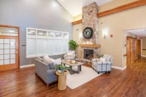 indoor soft seating and a fireplace at Patewood Post Acute