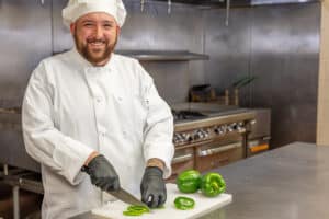 chef in the kitchen at the Patewood Post Acute facility