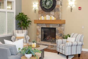 indoor soft seating and a fireplace at Patewood Post Acute