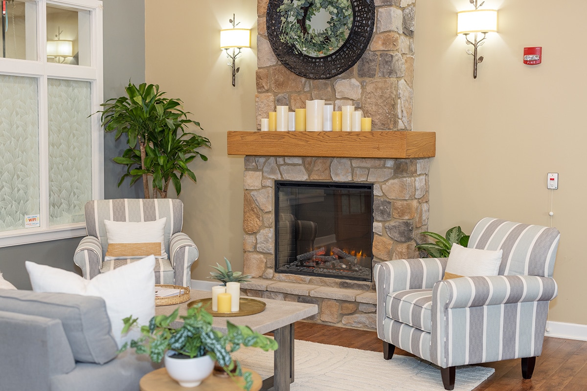 indoor soft seating and a fireplace at Patewood Post Acute